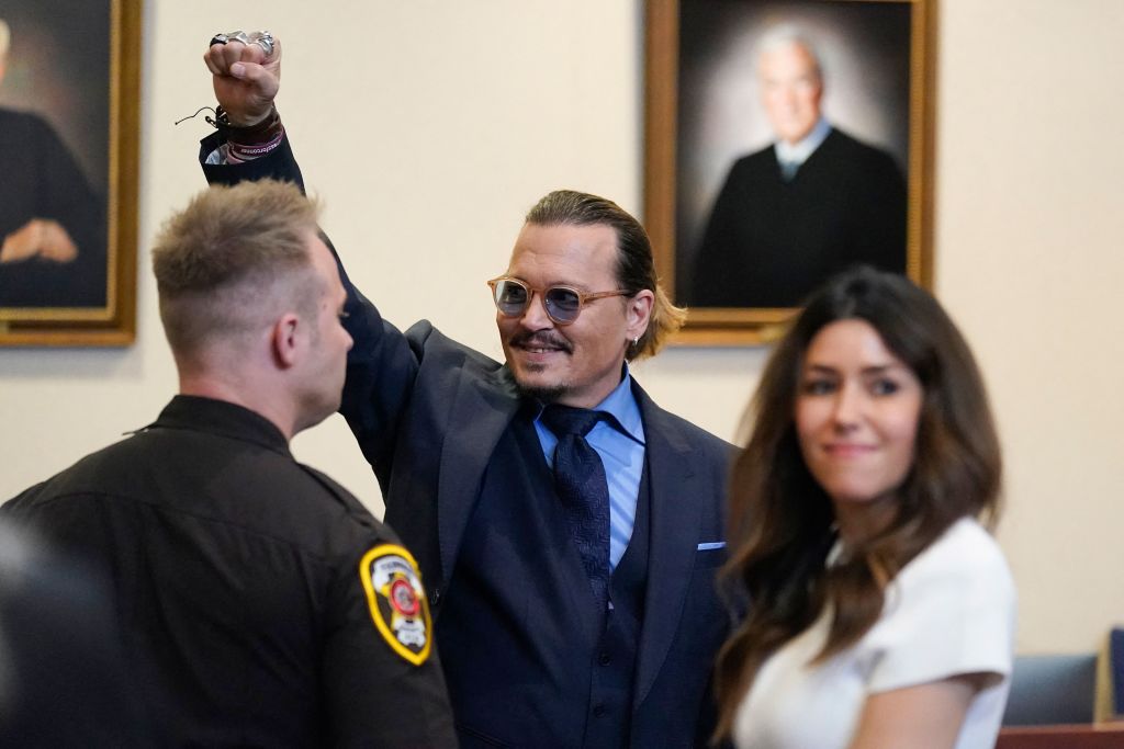 Actor Johnny Depp gestures to spectators in court after closing arguments at the Fairfax County Circuit Courthouse in Fairfax, Virginia, on May 27, 2022. (Steve Helber—Getty Images)