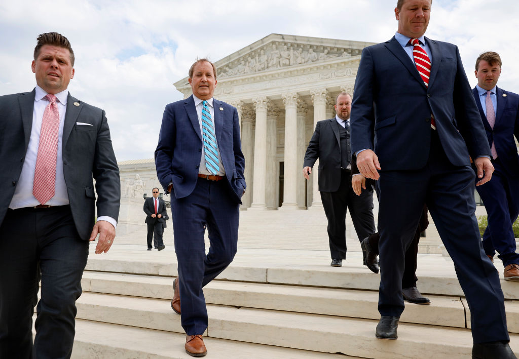 Texas Attorney General Ken Paxton (C), Texas Solicitor General Judd E. Stone and Missouri Attorney General Eric Schmitt walk out of the U.S. Supreme Court after arguments in their case about Title 42 on April 26 in Washington, DC. (Chip Somodevilla—Getty Images)