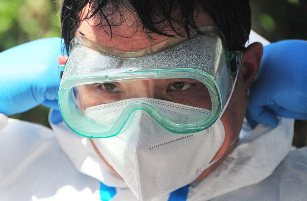A staff member's protective glasses and suit are drenched in sweat after disinfection work at a residential community on May 2, 2022 in Shanghai, China. (Yang Jianzheng/VCG via Getty Images)
