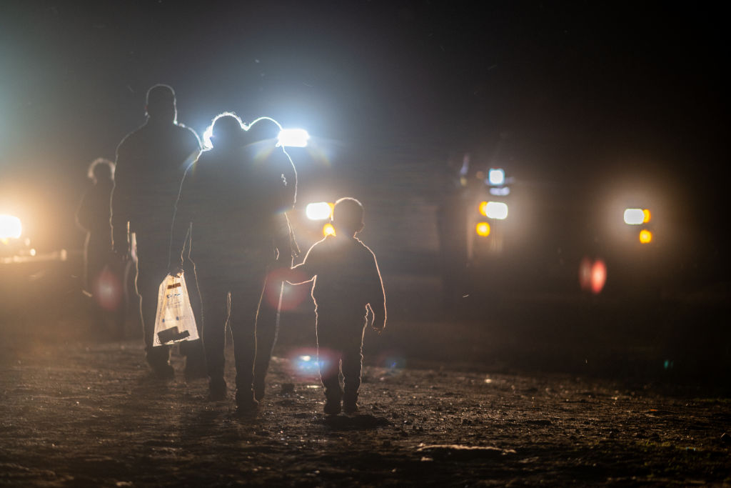 A migrant family walks to be processed by border patrol officers after crossing the Rio Grande into the U.S. in Roma, Texas, on May 5, 2022. (Brandon Bell—Getty Images)