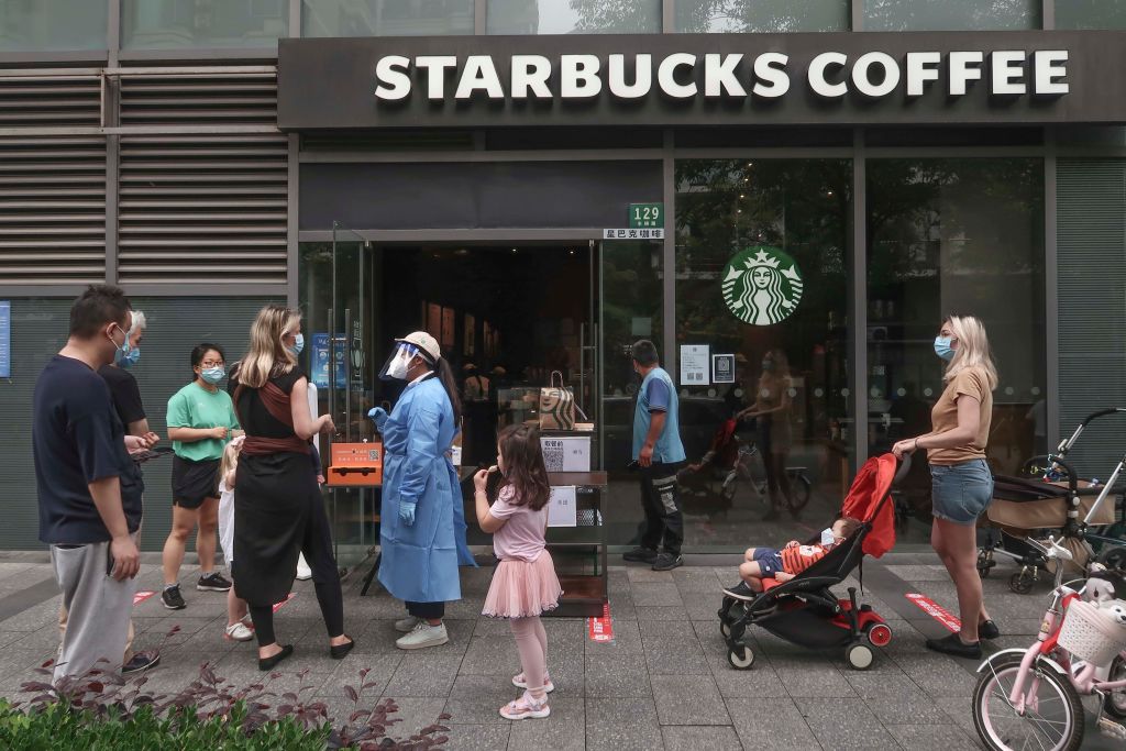 Customers pick up orders at a Starbucks store on May 30, 2022 in Shanghai, China. (VCG via Getty Images—2022 VCG)