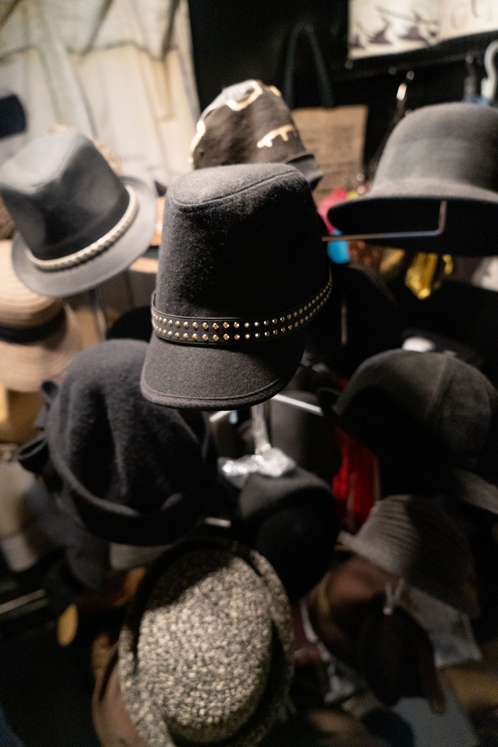 An assortment of Katherine Massey's beloved hats adorn a hat rack in her home.