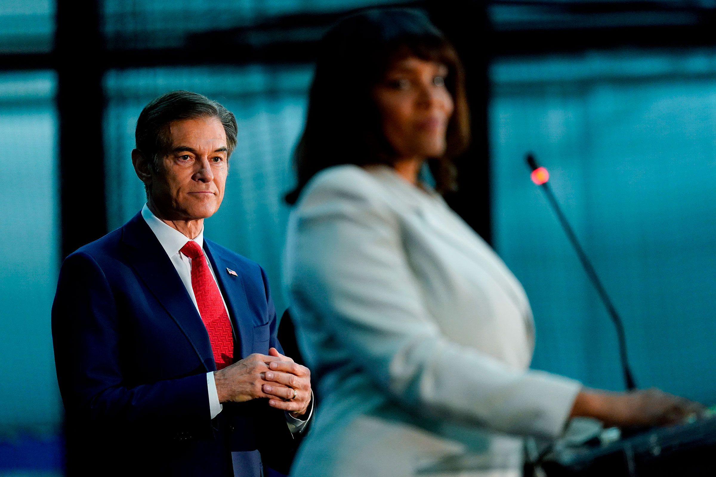 Mehmet Oz, left, looks on as Kathy Barnette finishes her remarks in Newtown, Pa., on May 11, 2022. (Matt Rourke—AP)