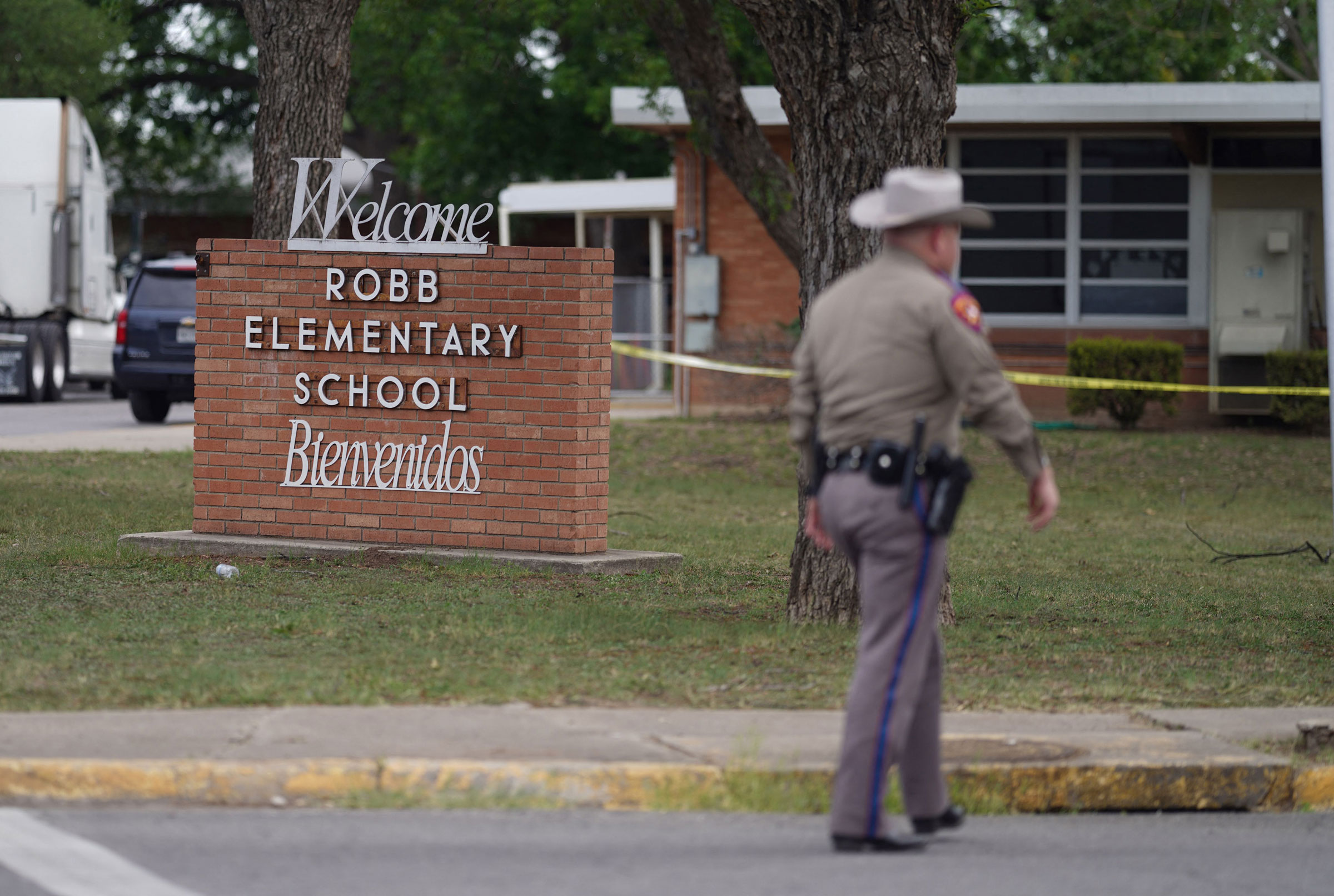 An officer walks outside of Robb Elementary School in Uvalde, Texas, on May 24, 2022. (Allison Dinner—AFP/Getty Images)