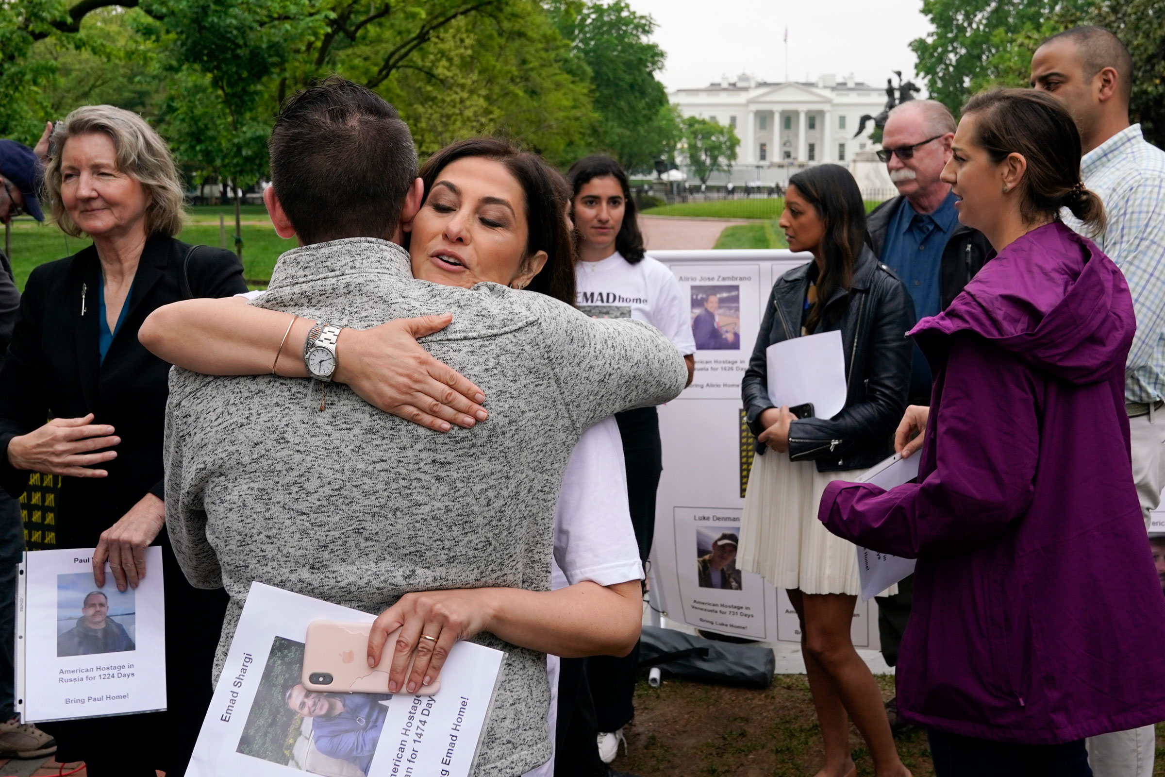 Neda Shargi, sister of Iranian prisoner Emad Shargi, hugs former Syrian hostage Sam Goodwin