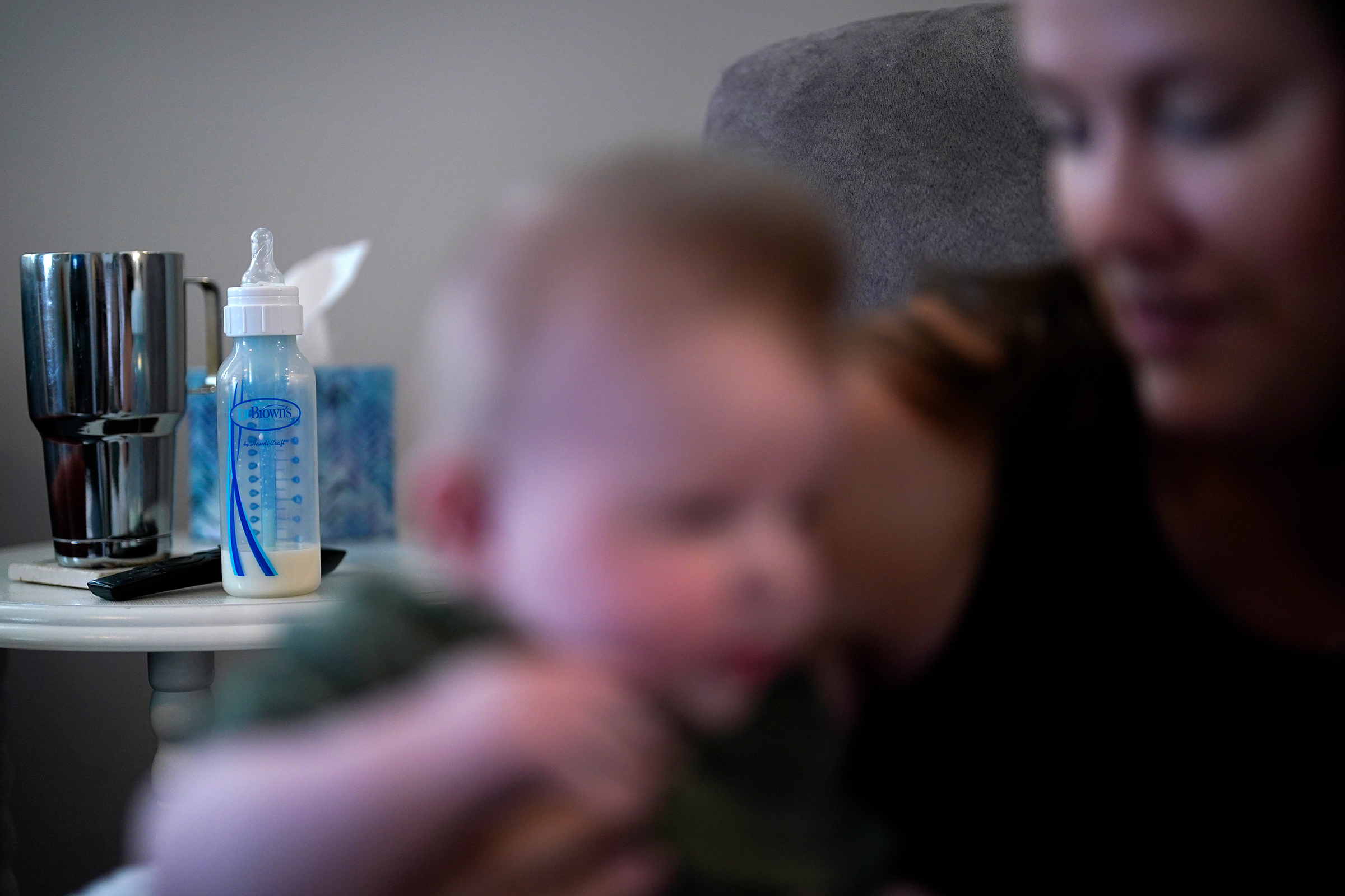 Ashley Maddox holds her 5-month-old son, Cole, after feeding him with formula she bought through a Facebook group of mothers in need Thursday, May 12, in Imperial Beach, Calif. (Gregory Bull—AP)