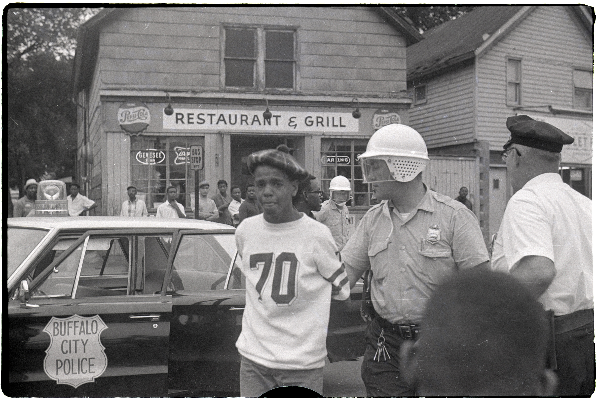 A Buffalo youth is led away after being arrested by police during the second night of protests in the city, June 28, 1967. (Bettmann Archives/Getty Images)