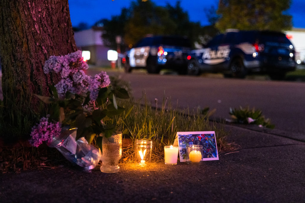 BUFFALO, NY - MAY 14: A small vigil set up across the street from a Tops grocery store on Jefferson Avenue in Buffalo, where a heavily armed 18-year-old White man entered the store in a predominantly Black neighborhood and shot 13 people, killing ten, Saturday, May 14, 2022. This incident also illuminates the ramifications of a firearm heavy nation. The burden of those ramifications disproportionately impacts the Black community and has done so since the Second Amendment was written into law.  (Matt Burkhartt—Getty Images)