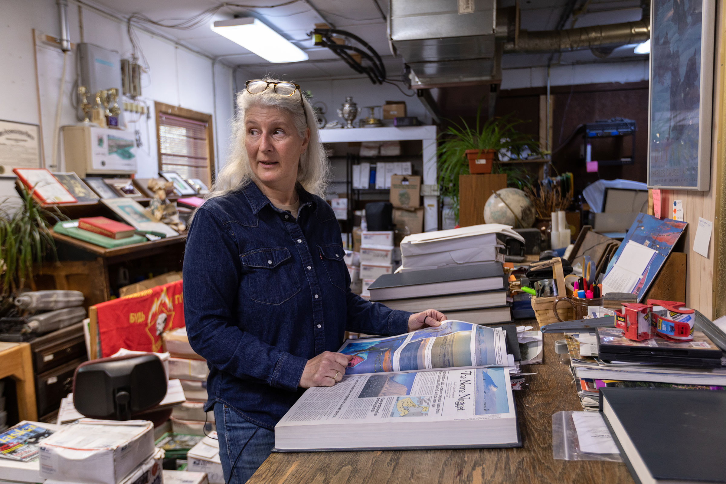 Diana Haecker, editor of the Nome Nugget, looks for climate stories in the archives of Alaska’s oldest newspaper. (Acacia Johnson for TIME)
