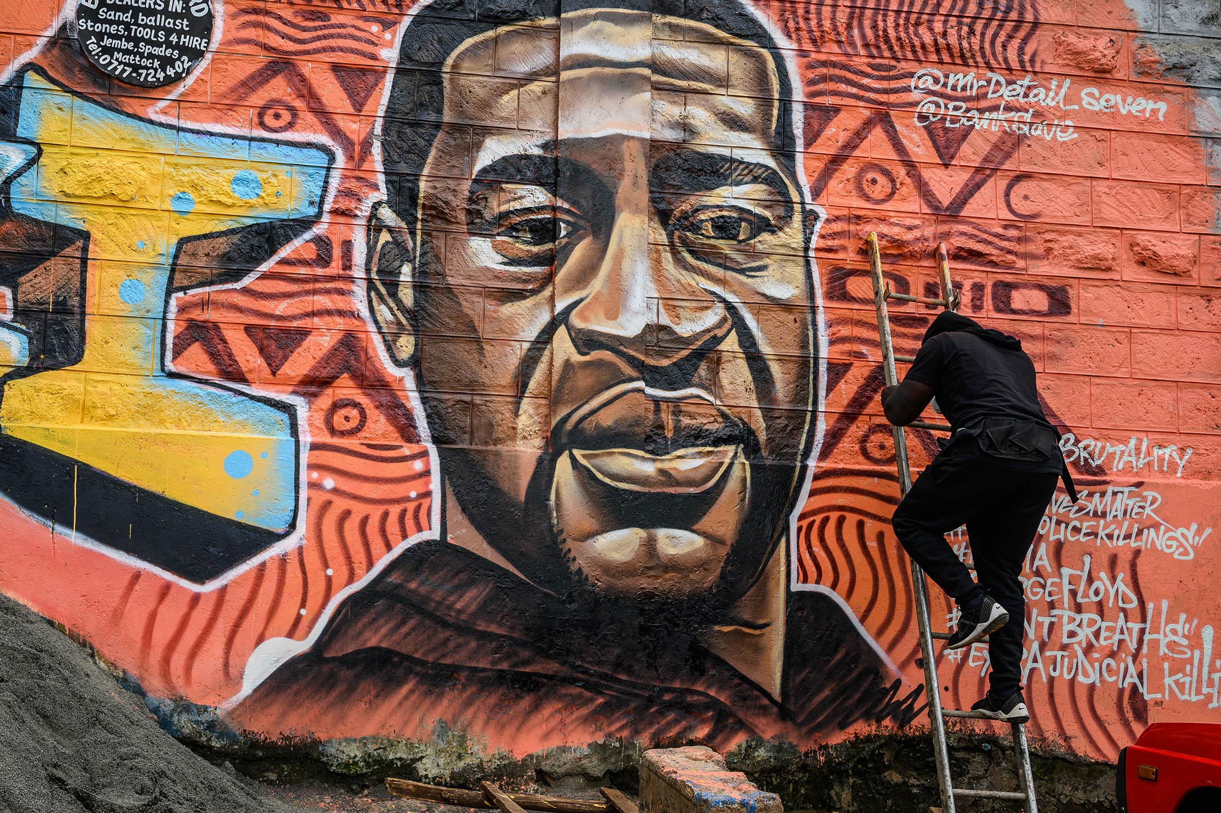 Kenyan mural artist Allan Mwangi, also known as Mr.detail.seven, paints a graffiti mural in the Kibera slum in Nairobi on June 3, 2020, depicting the American, George Floyd, who was killed by a police officer in Minneapolis, in the United States.