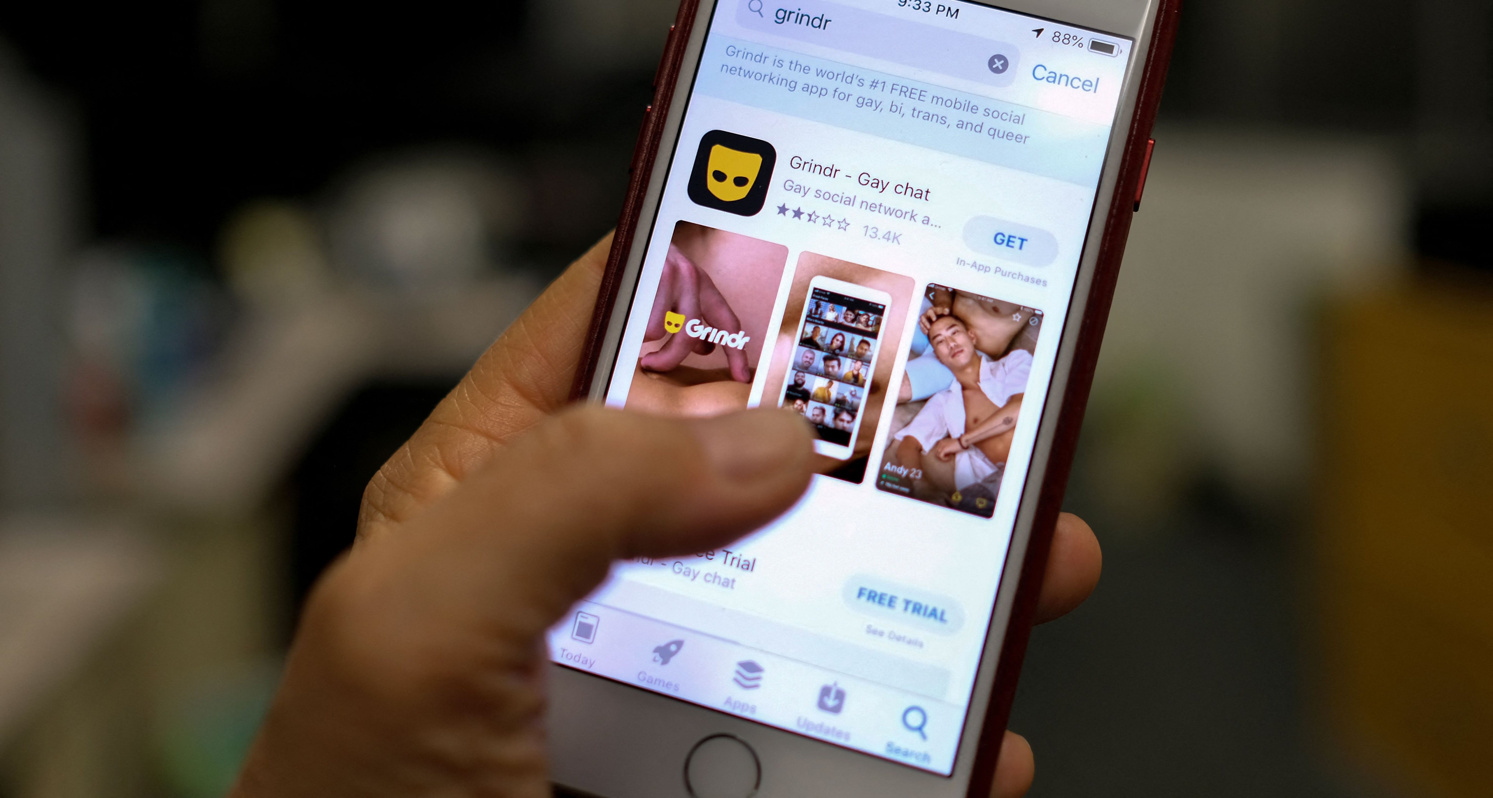 A person looks at the Grindr app in the App Store on a phone in Los Angeles on March 27, 2019. (Chris Delmas—AFP/Getty Images)