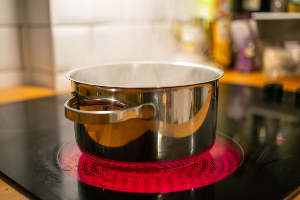 A saucepan of boiling water sits on an induction hob in a kitchen in Berlin, Germany on August 27, 2021. (Fernando Gutierrez-Juarez/picture alliance—Getty Images)