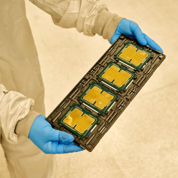 An Intel employee with a tray of Ponte Vecchio microchips before the heat spreader is attached at the company's complex in Chandler, Ariz., on Nov. 17, 2021.
