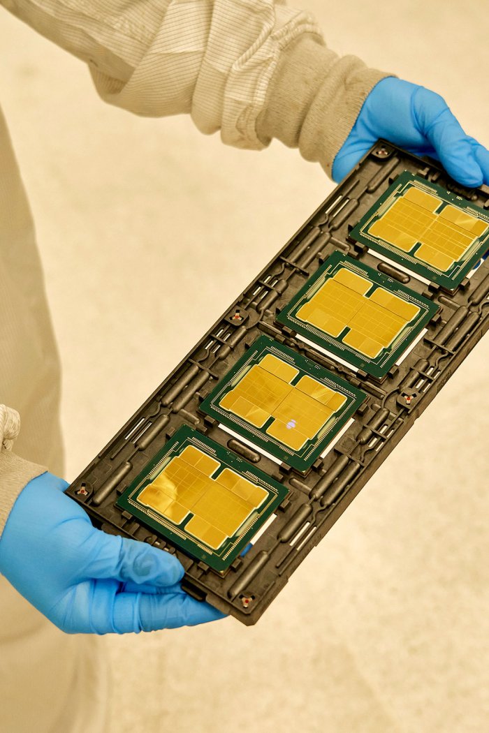 An Intel employee with a tray of Ponte Vecchio microchips before the heat spreader is attached at the company's complex in Chandler, Ariz., on Nov. 17, 2021.