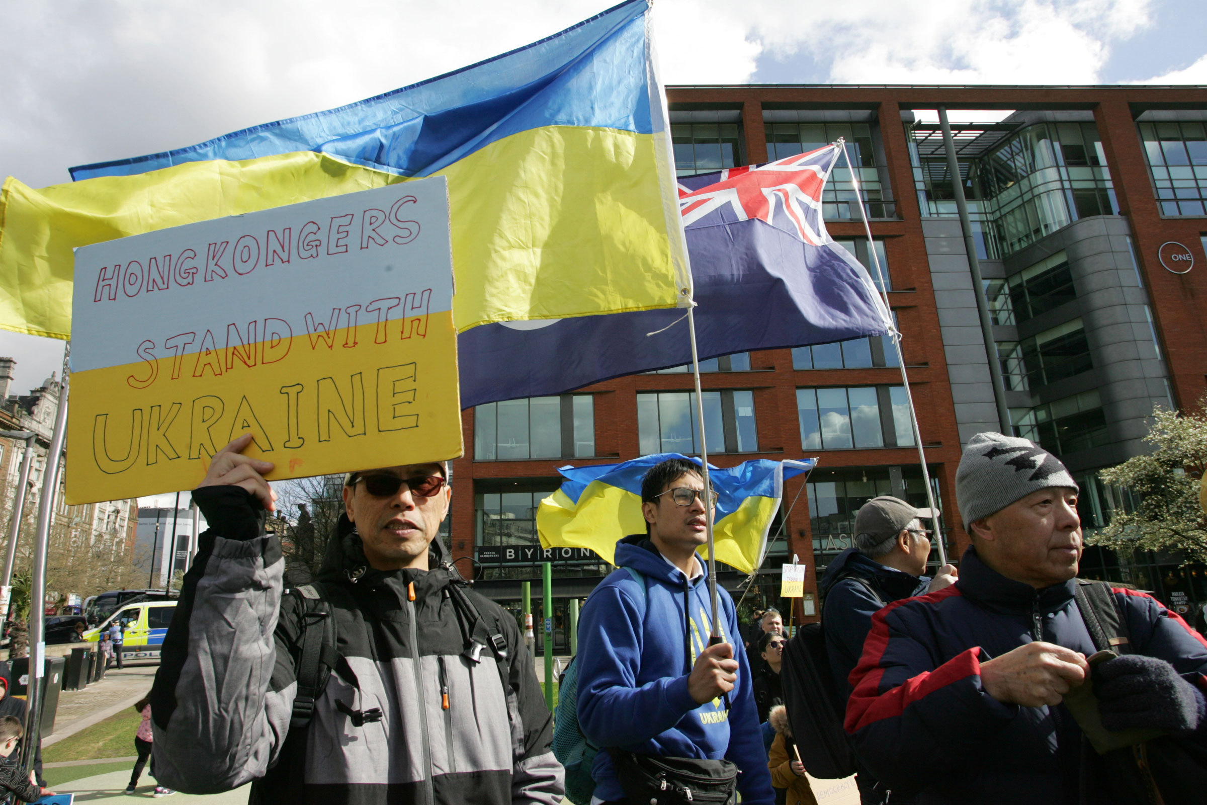 A member of Manchester's "Hong Kong" community, shows his and friends solidarity with Ukraine and its people