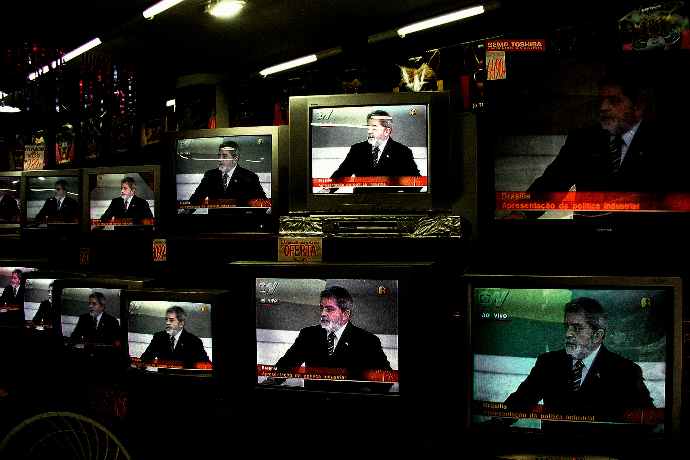 Inside a shop in São Paulo in 2004, Lula is seen on television giving a speech responding to accusations of corruption against his government. (Alex Majoli—Magnum Photos)