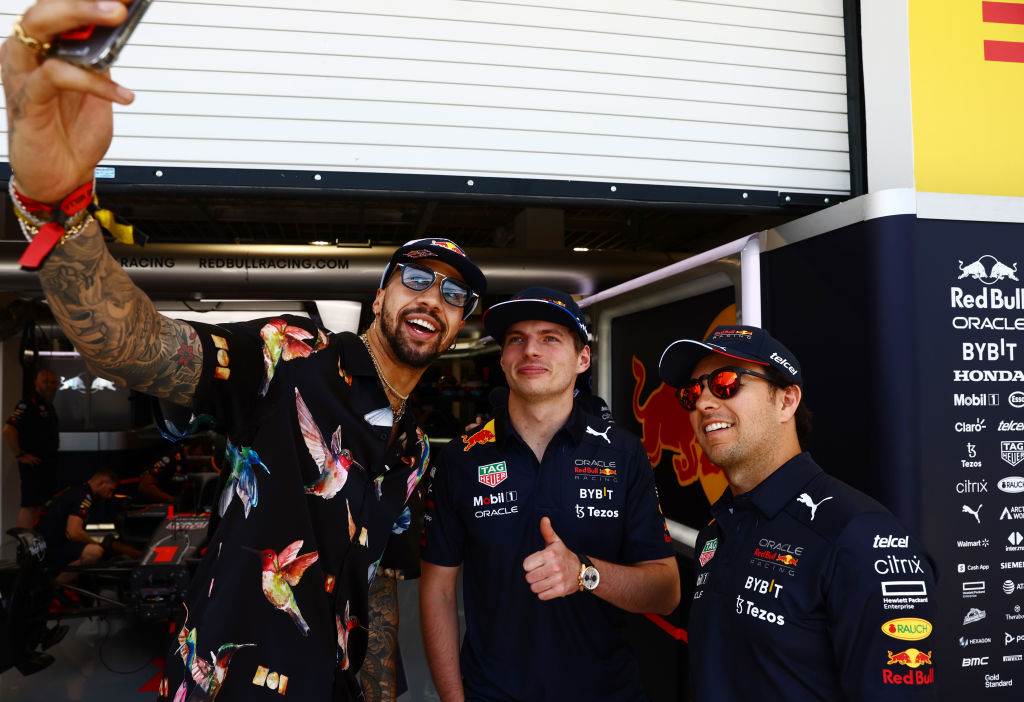 Max Verstappen of the Netherlands and Oracle Red Bull Racing and Sergio Perez of Mexico and Oracle Red Bull Racing pose for a photo with fencer Miles Chamley-Wilson prior to practice ahead of the F1 Grand Prix of Miami at the Miami International Autodrome on May 06, 2022 in Miami, Florida. (Photo by ) (Mark Thompson—Getty Images)
