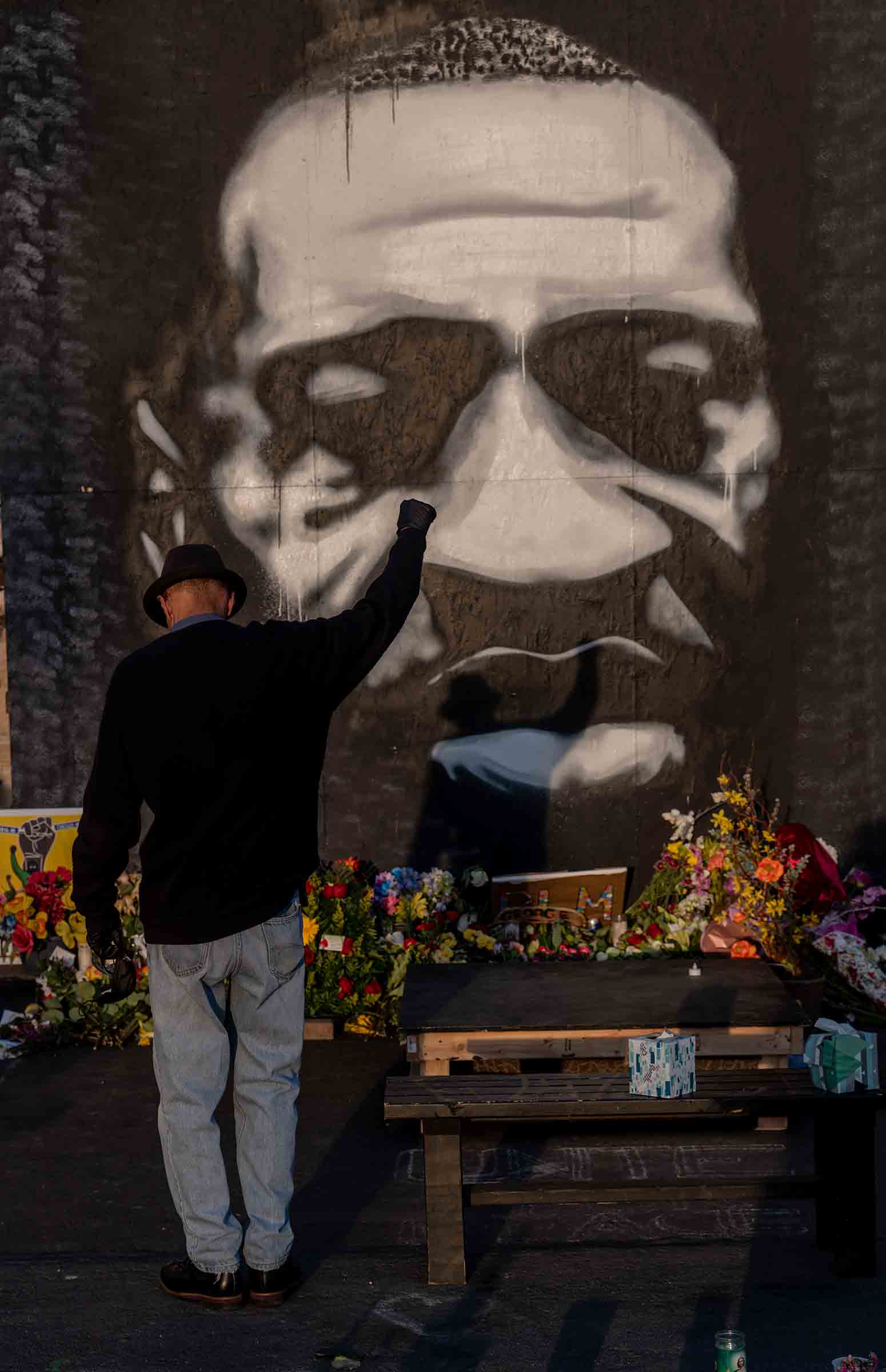 A man pays tribute to George Floyd at the memorial outside Cup Foods in Minneapolis, April 2021. (Ruddy Roye for TIME)