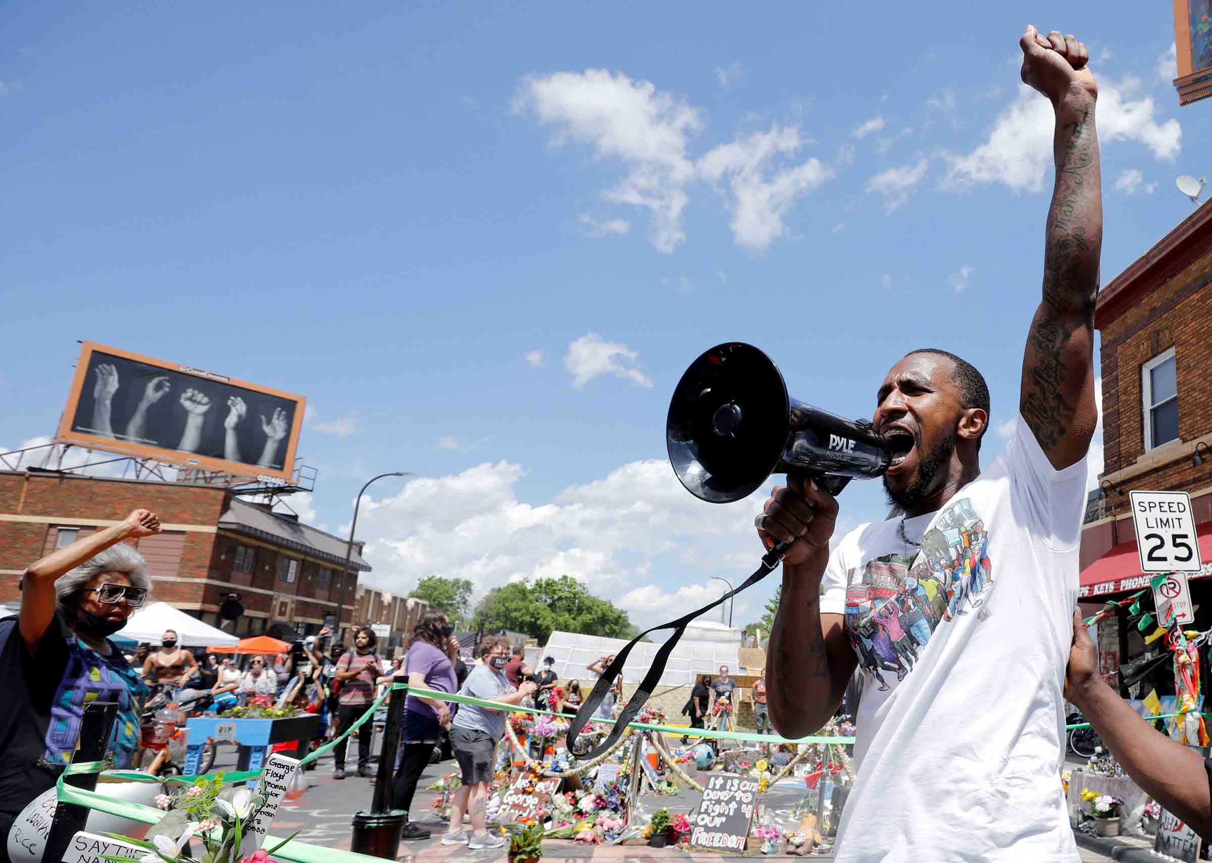 Community organizer Tommy McBrayer Jr. leads a chant in solidarity with George Floyd on the first anniversary of his death, at George Floyd Square in Minneapolis, on May 25, 2021. (Nicholas Pfosi—Reuters)