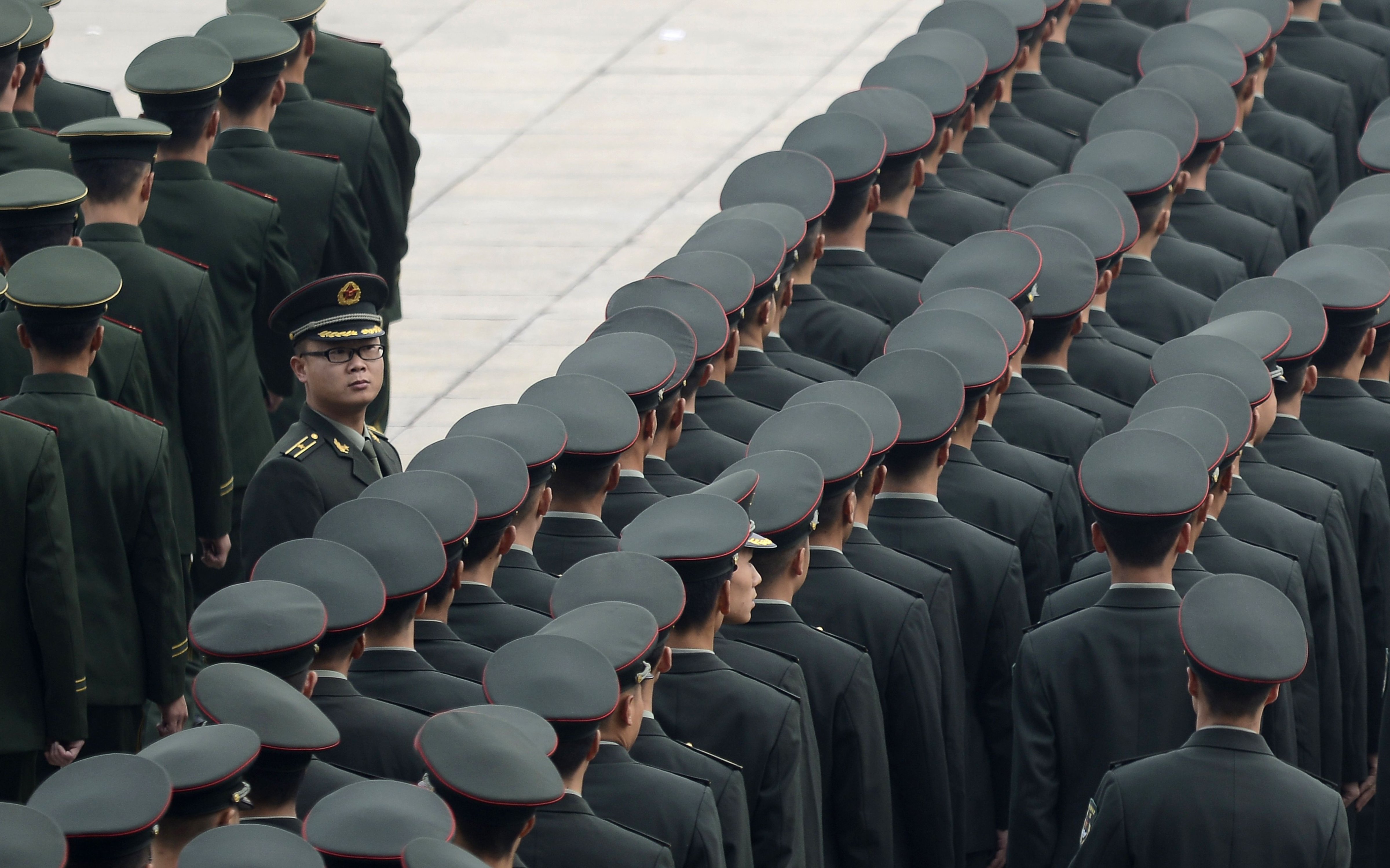 Chinese People's Liberation Army (PLA) soldiers stand in line after a commemoration in Beijing on November 11, 2016. (Wang Zhao—AFP/Getty Images)