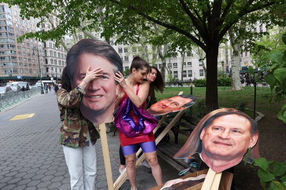 Members and supporters of Abortion Access Front tape cutouts of Supreme Court justices to poles before a protest at Foley Square in Manhattan, May 3, 2022. (Caitlin Ochs/The New York Times)
