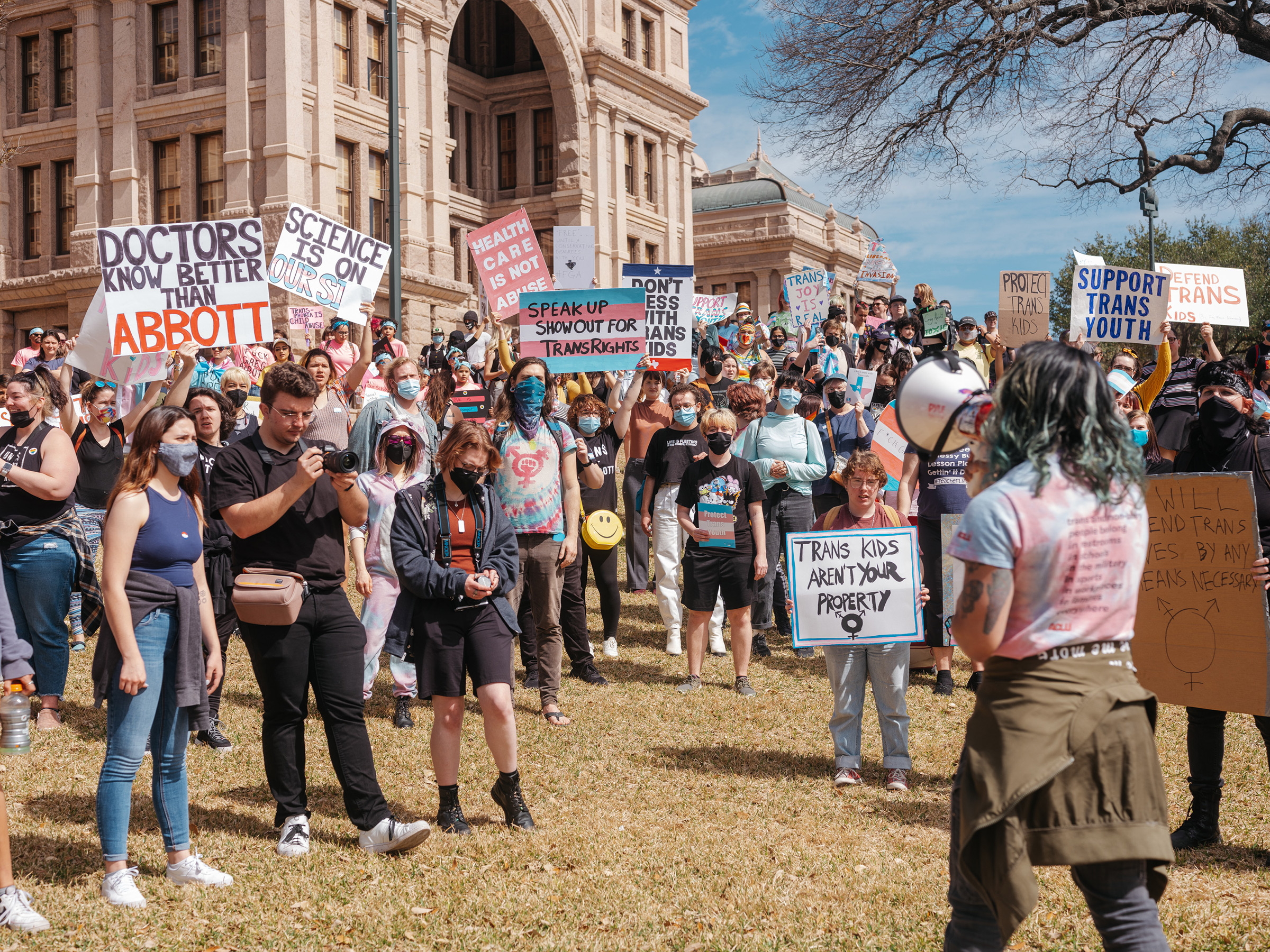 Demonstrators protest a Texas policy to regard gender-affirming treatments for transgender youth as 
