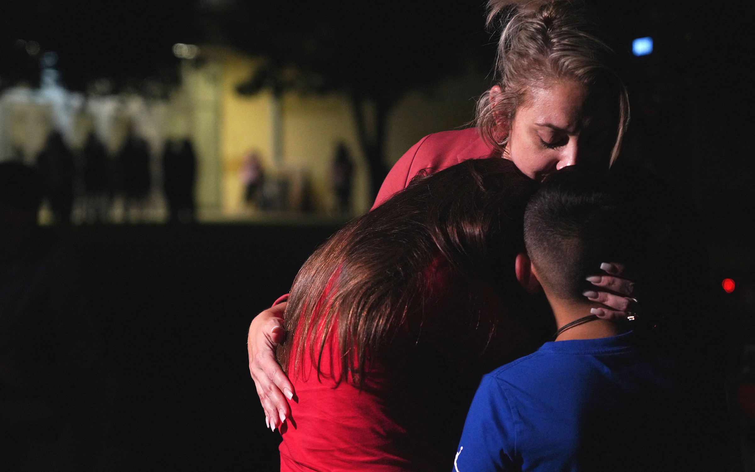 A family hugs outside the Willie de Leon Civic Center where grief counseling will be offered in Uvalde, Texas, on May 24, 2022. (Allison Dinner—AFP/Getty Images)