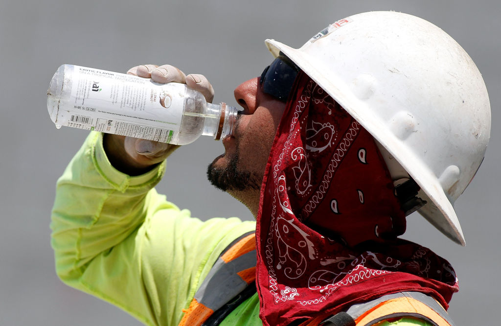 A Phoenix area construction worker drinks water at a job site on June 20, 2017 in Phoenix, Arizona, where record temperatures were set to reach 118 to 120 degrees F. (Ralph Freso/Getty Images)