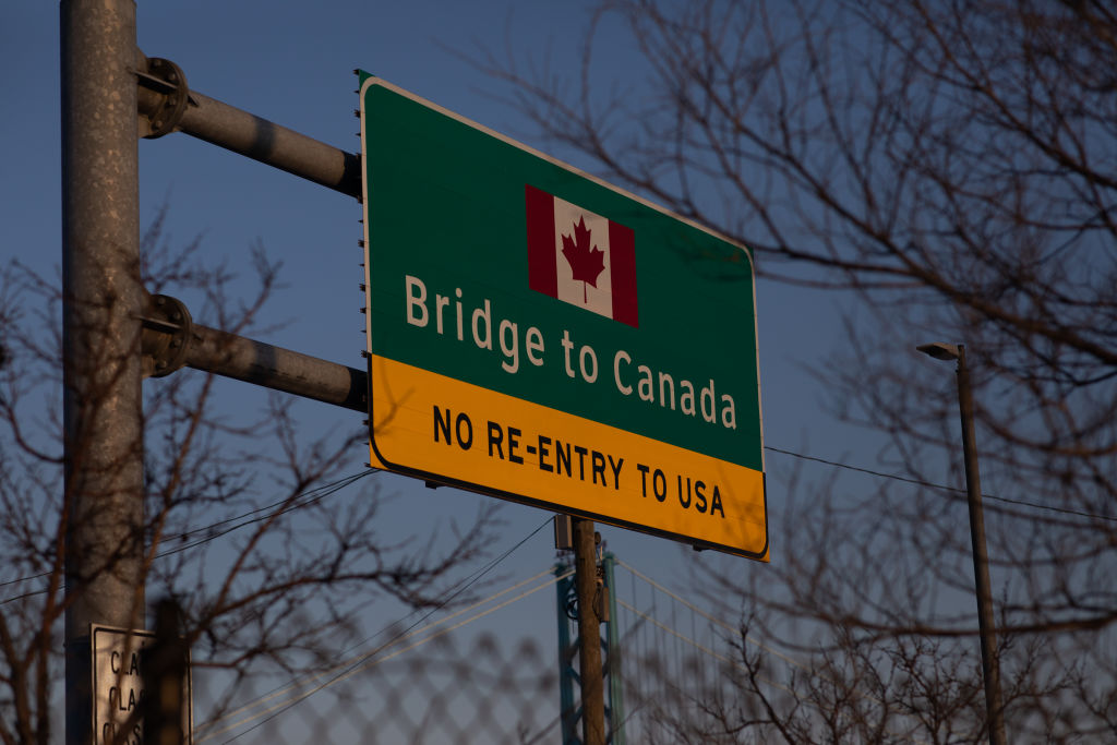 A sign leading to the Ambassador bridge to Canada in in Detroit, Michigan, on February 8, 2022. (Photo by Emily Elconin—Getty Images)