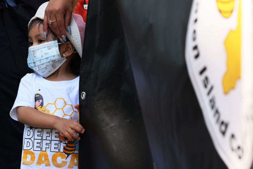A young child wearing a "Defend DACA" shirt joins people as they gather for a rally to celebrate the 10th anniversary of Deferred Action for Childhood Arrivals (DACA) in Battery Park on June 15, 2022 in New York City. (Photo by Michael M. Santiago/Getty Images)
