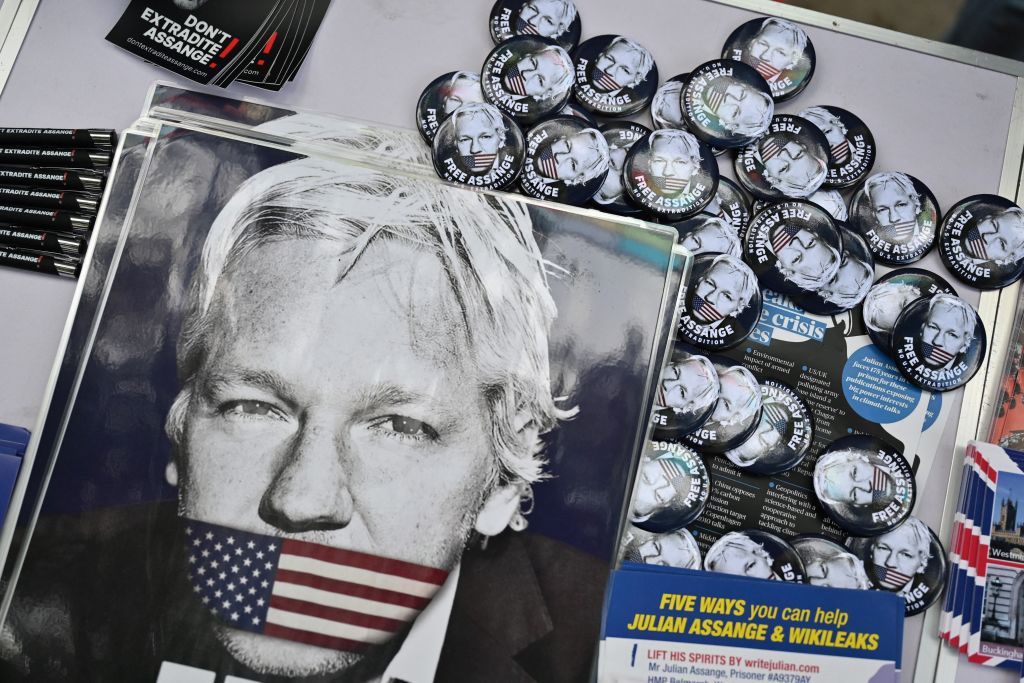 Posters, badges, and leaflets picturing WikiLeaks founder Julian Assange are displayed on a table in front of the Home Office building, in London, on May 17, 2022, during a demonstration to protest against the extradition of Assange. (Justin Tallis—AFP via Getty Images)