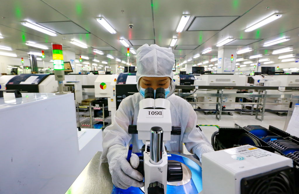 A worker inspects the quality of products at a manufacturer of semiconductors in Suining in southwest China's Sichuan province Tuesday, May 24, 2022. (Zhong Min—Feature China/Future Publishing/Getty Images)