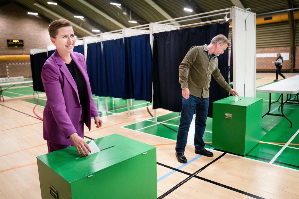 Danish Prime Minister Mette Frederiksen and her husband Bo Tengberg cast their ballots at a polling station in Vaerloese near Copenhagen, Denmark, on Jun. 1, 2022, as traditionally euroskeptic Denmark votes in a referendum on whether to overturn its opt-out on the EU's common defence. (Ritzau Scanpix—AFP via Getty Images)