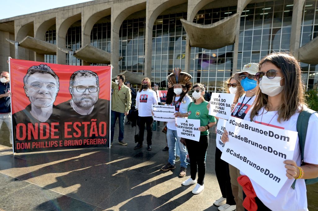 Employees of the  National Indigenous Foundation (FUNAI) and members of Social Movements protest outside the Ministry of Justice in Brasília, on Jun. 14, 2022 over missing British journalist Dom Phillips and Brazilian Indigenous affairs specialist Bruno Pereira. (Evaristo Sa—AFP/Getty Images)