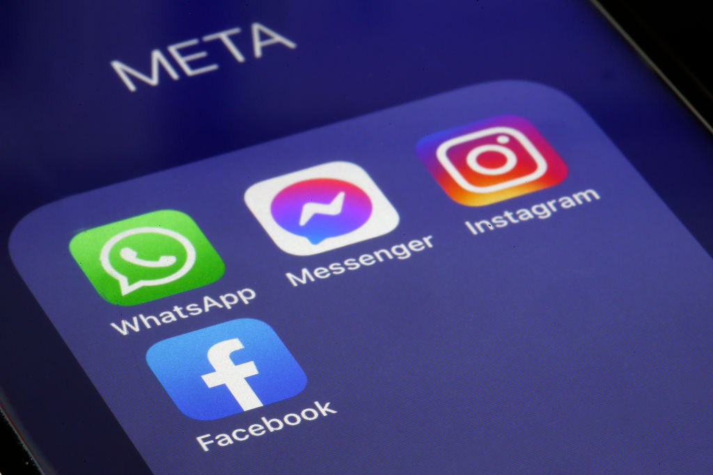 The logos of applications, WhatsApp, Messenger, Instagram and facebook belonging to the company Meta are displayed on the screen of an iPhone on February 03, 2022 in Paris, France. (Photo illustration by Chesnot-Getty Images)