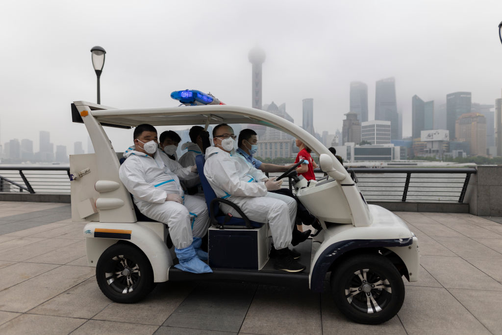 Staff with protective suits drive along the Bund on June 1, 2022 in Shanghai, China. (Hu Chengwei/Getty Images)