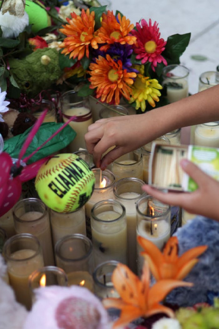 UVALDE, TEXAS - JUNE 03: Brad Fowler of San Antonio, Texas, lights up candles at a memorial dedicated to the victims of the mass shooting at Robb Elementary School on June 3, 2022 in Uvalde, Texas. 19 students and two teachers were killed on May 24 after an 18-year-old gunman opened fire inside the school.