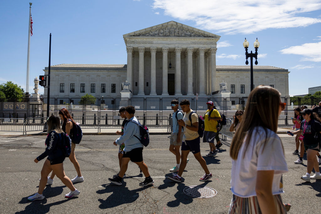 Student tour groups walk past the U.S. Supreme Court Building on June 20, 2022 in Washington, DC. This week the court will release more opinions for cases including decisions on abortion rights, guns, religion and climate change. (Anna Moneymaker—Getty Images)