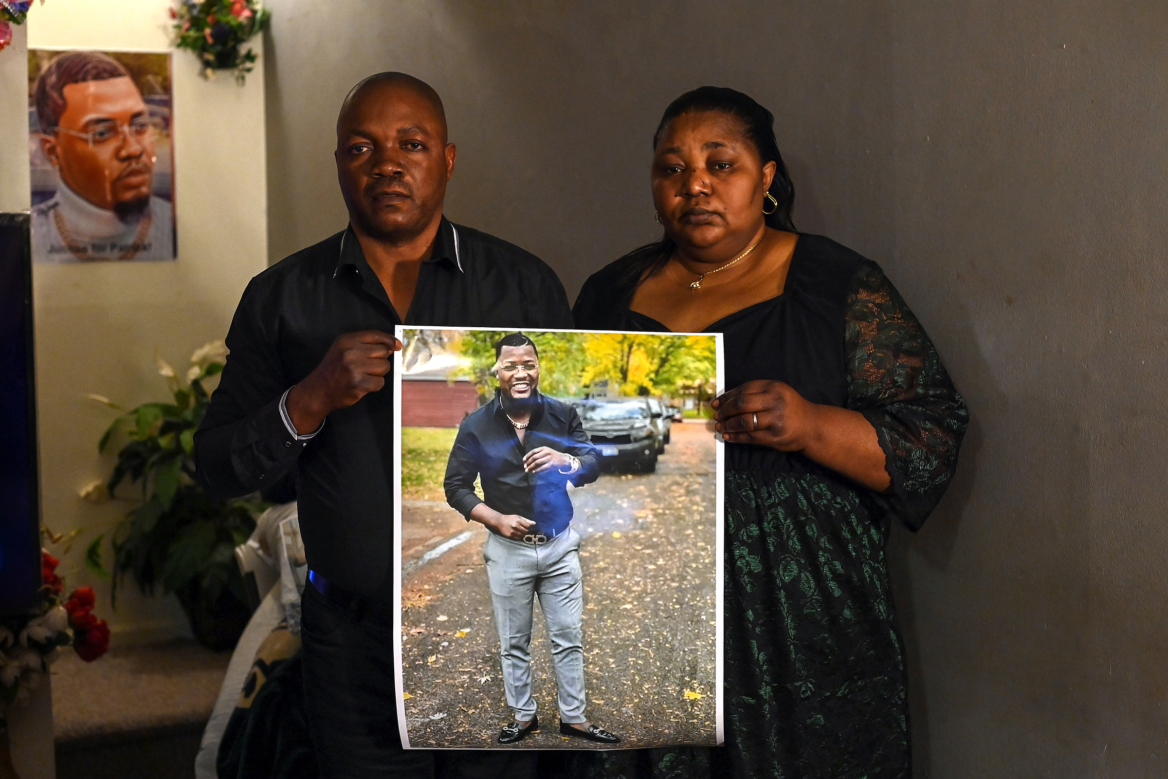 Patrick Lyoya's parents Peter Lyoya and Dorcas Lyoya pose for a portrait as they hold a photo of their son at their home on April 15, 2022 in Lansing, Mich. (Joshua Lott—The Washington Post/Getty Images)