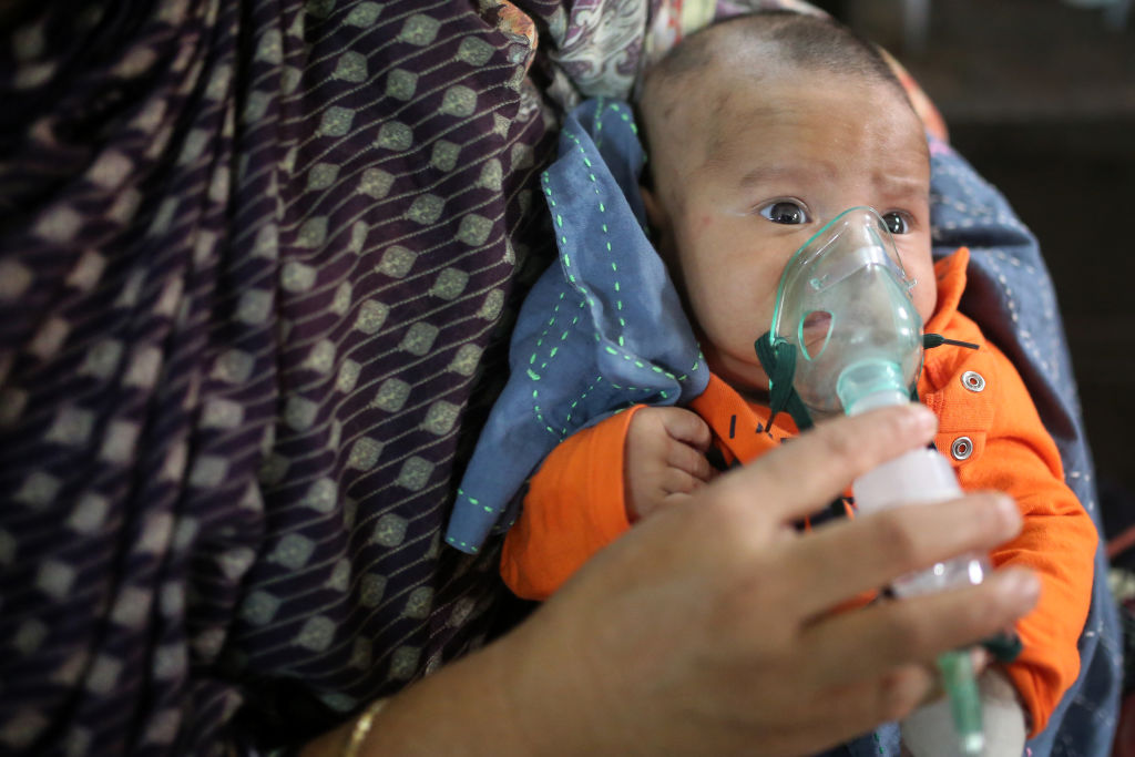 A baby who is suffering from respiratory disease receives treatment inside at Dhaka Shishu (Children) Hospital in Dhaka, Bangladesh on February 24, 2021. Children are particularly vulnerable to air pollution as their lungs are not fully developed like adults. (Syed Mahamudur Rahman—NurPhoto/Getty Images)