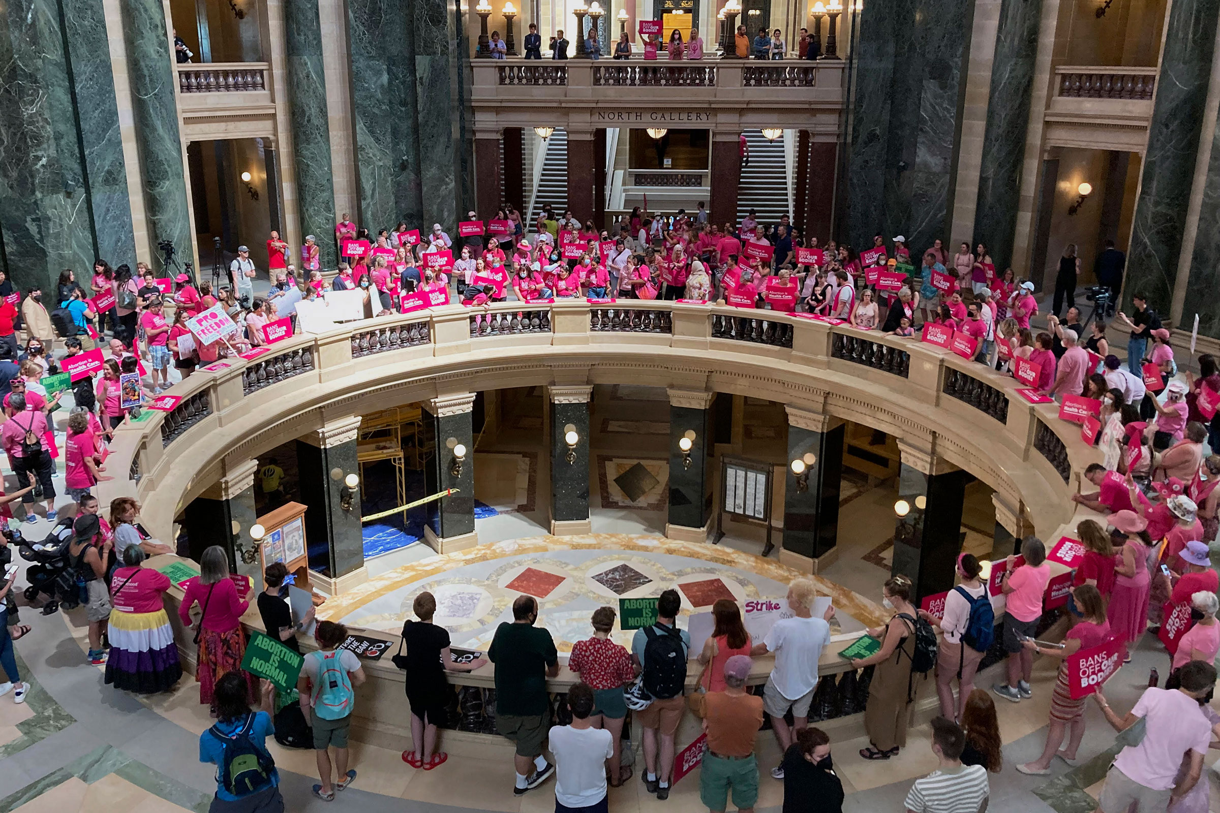Dozens of protesters gather in the Wisconsin state Capitol rotunda in Madison, Wis., on June 22, 2022, in hopes of convincing Republican lawmakers to repeal the state's 173-year-old ban on abortions.