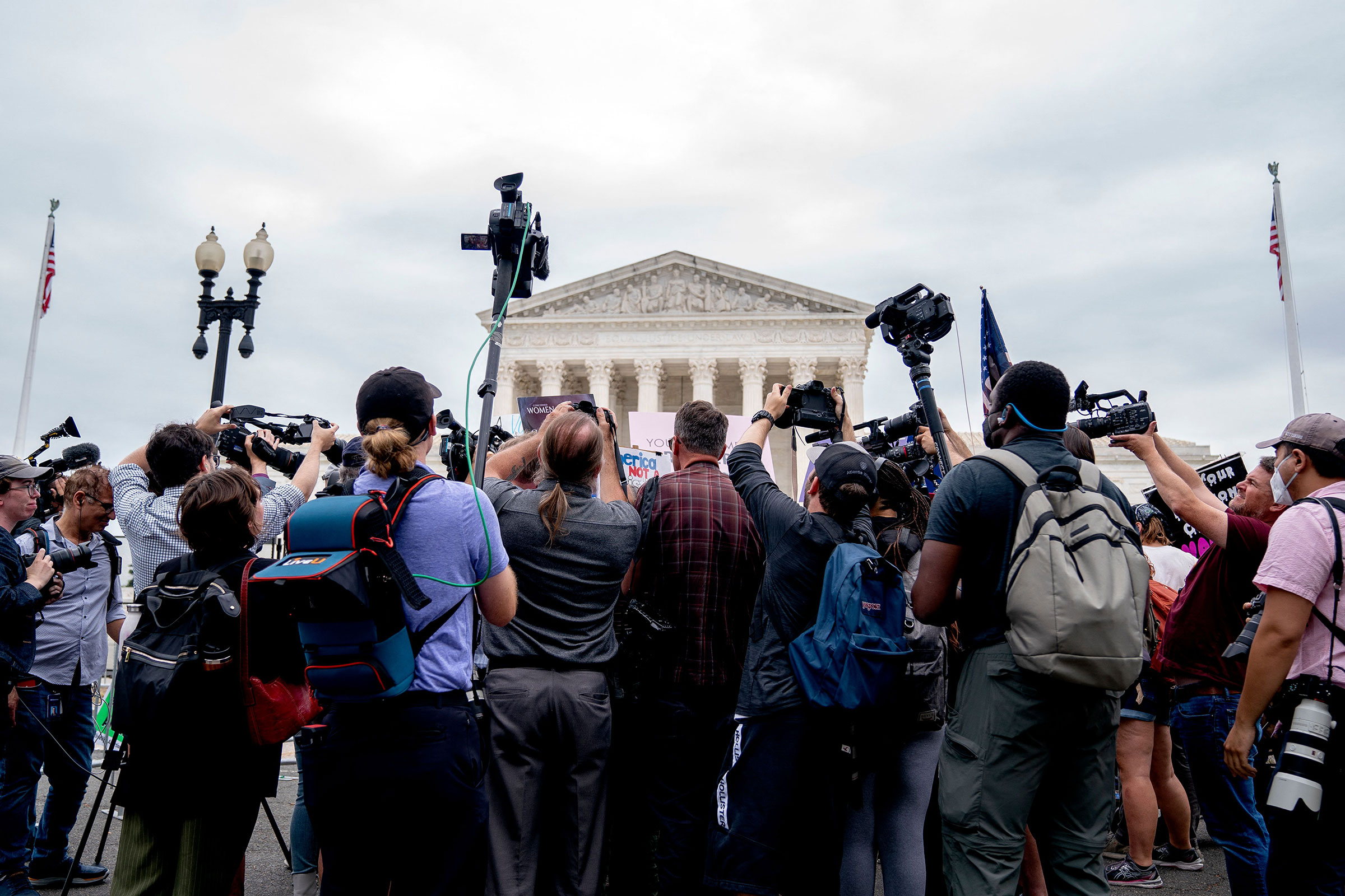Members of the media gather around anti-abortion and abortion activists demonstrating outside the Supreme Court in Washington, on June 21, 2022. (Stefani Reynolds—AFP/Getty Images)