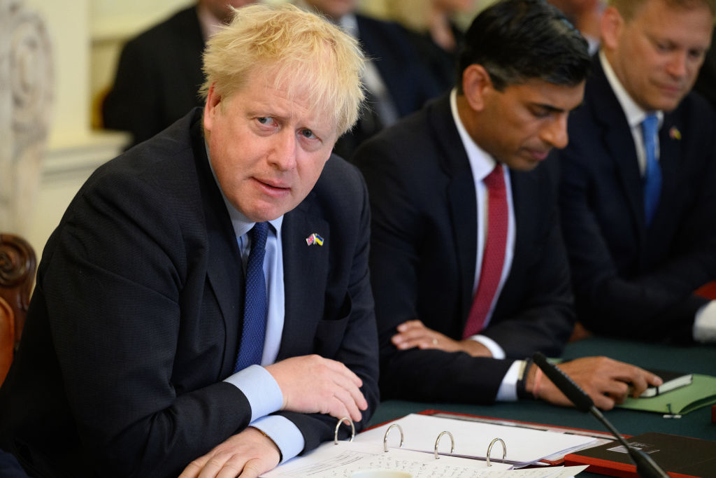 Britain's Prime Minister Boris Johnson (L) addresses his Cabinet ahead of the weekly Cabinet meeting in Downing Street on June 7 2022 in London, England, a day after he survived a no-confidence vote among Conservative lawmakers. (Leon Neal—WPA Pool/Getty Images)