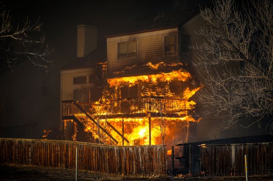 A home burns after a fast moving wildfire swept through the area in the Centennial Heights neighborhood of Louisville, Colorado.