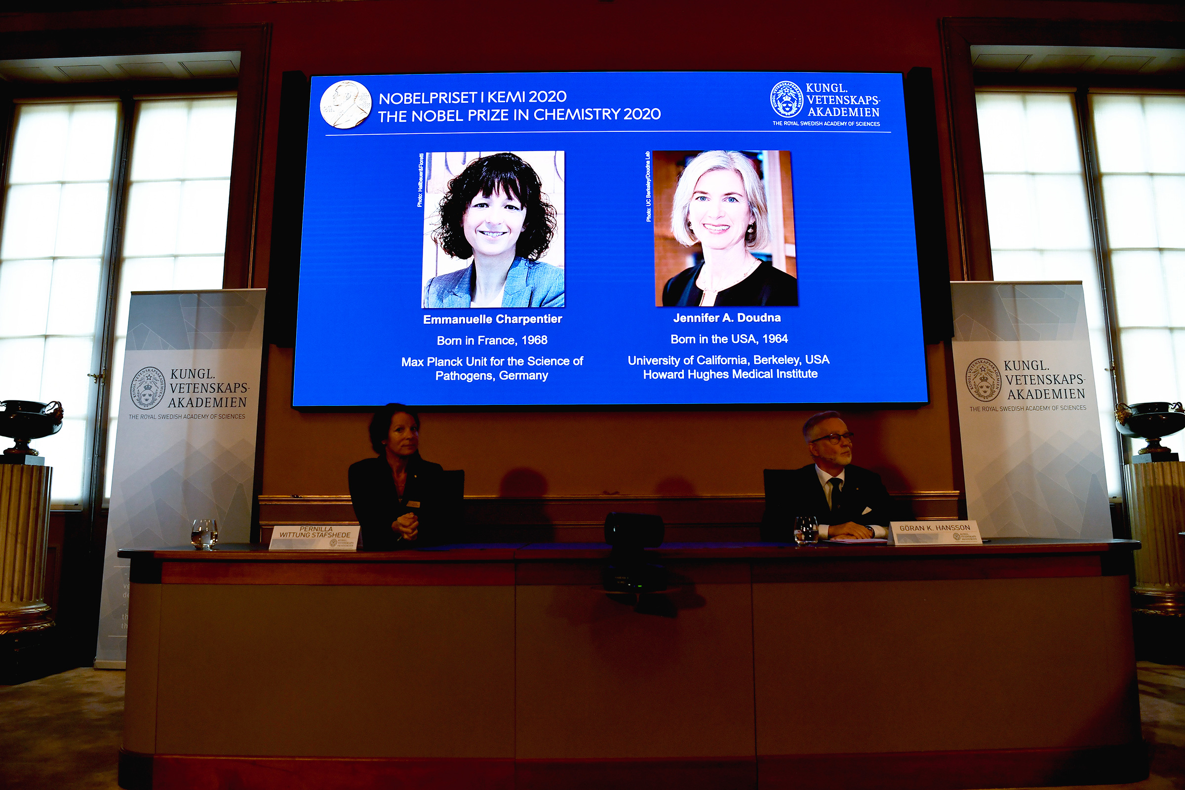Emmanuelle Charpentier, left on screen, and Jennifer Doudna are announced as the winners of the 2020 Nobel prize in Chemistry during a news conference at the Royal Swedish Academy of Sciences, in Stockholm, Sweden, Oct. 7, 2020. (Henrik Montgomery—TT/AP)