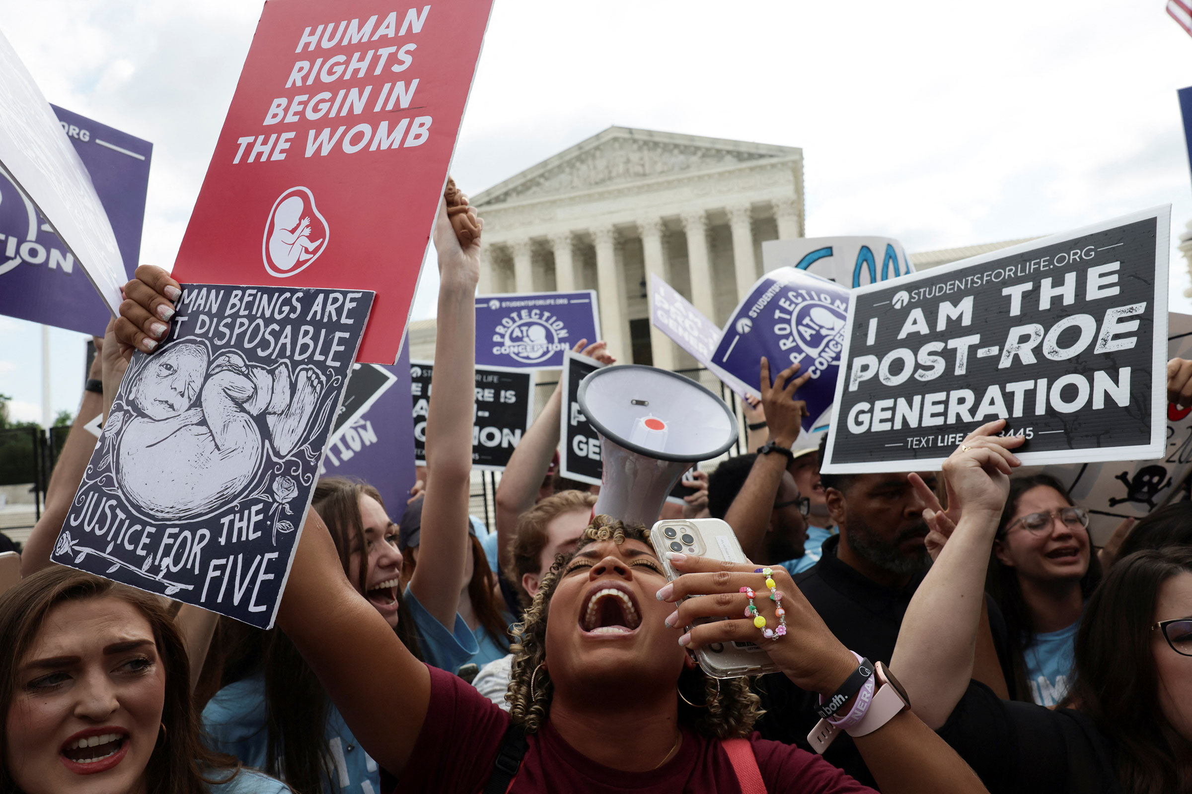 Anti-abortion demonstrators celebrate outside the United States Supreme Court as the court rules in the Dobbs v. Jackson Women’s Health Organization abortion case in Washington, D.C., June 24, 2022. (Evelyn Hockstein—Reuters)