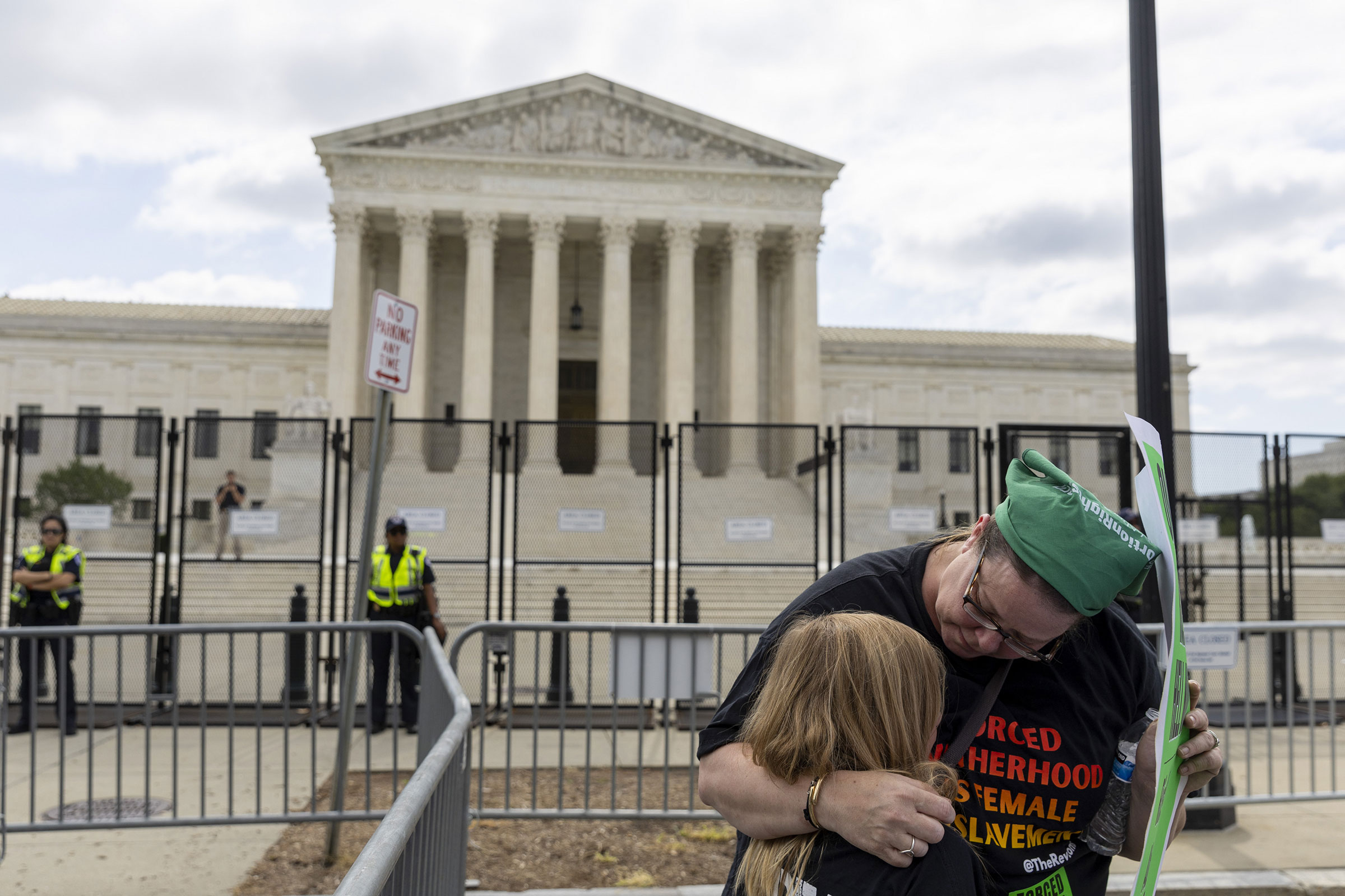 A women consoles her daughter as protesters gather in front of the U.S. Supreme Court in Washington, D.C., on Friday, June 24, 2022. (Tasos Katopodis—UPI/Shutterstock)