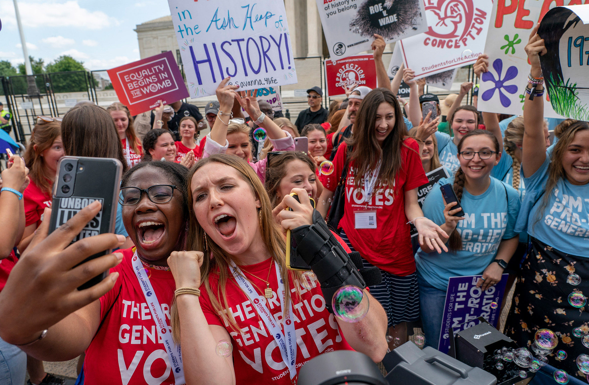 Anti-abortion protesters celebrate following the Supreme Court's decision to overturn Roe v. Wade in Washington, D.C., on June 24, 2022. (Gemunu Amarasinghe—AP)