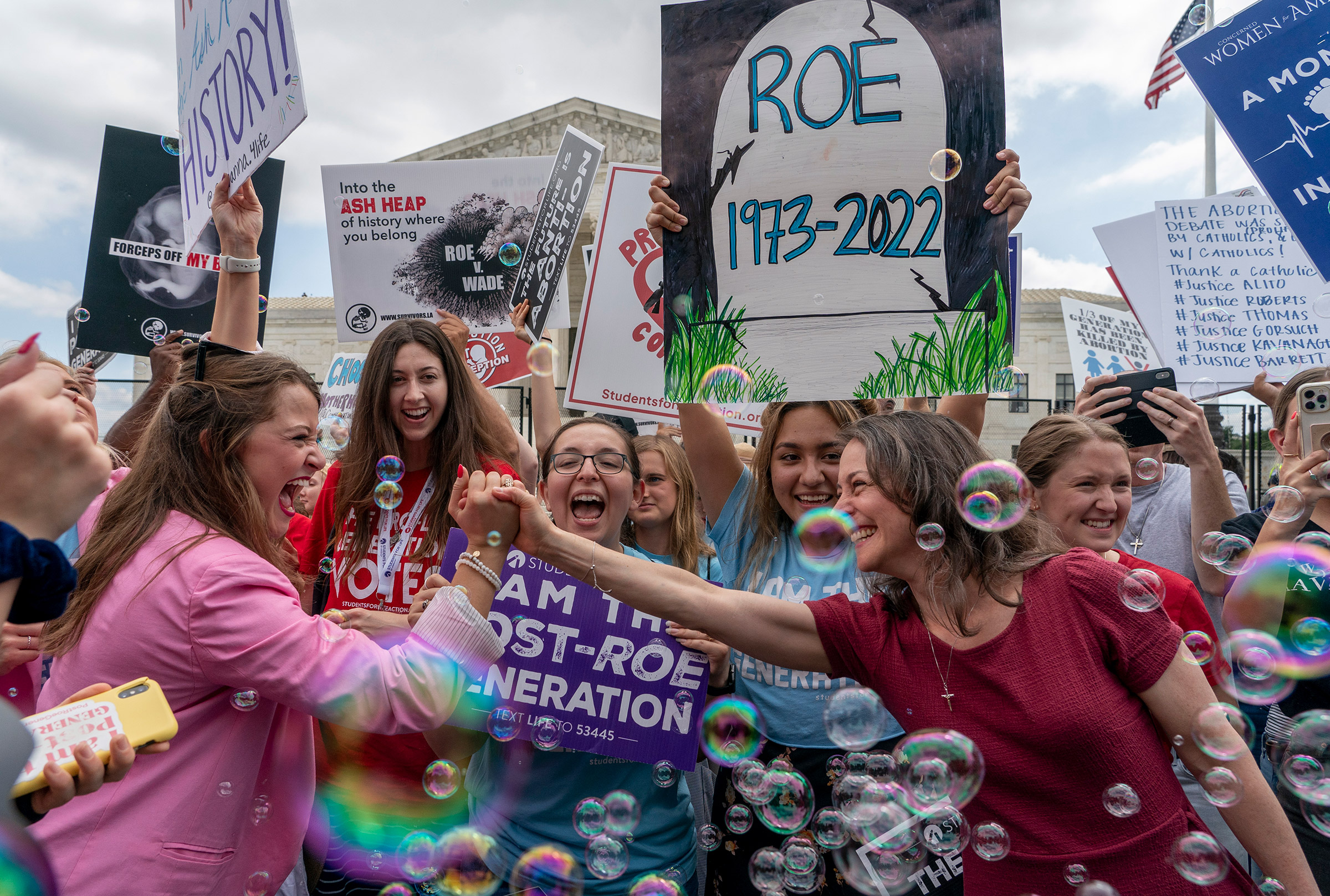 Anti-abortion protesters celebrate following the Supreme Court’s decision to overturn <em>Roe v. Wade,</em> outside the Supreme Court in Washington, D.C., June 24, 2022 (Gemunu Amarasinghe—AP)