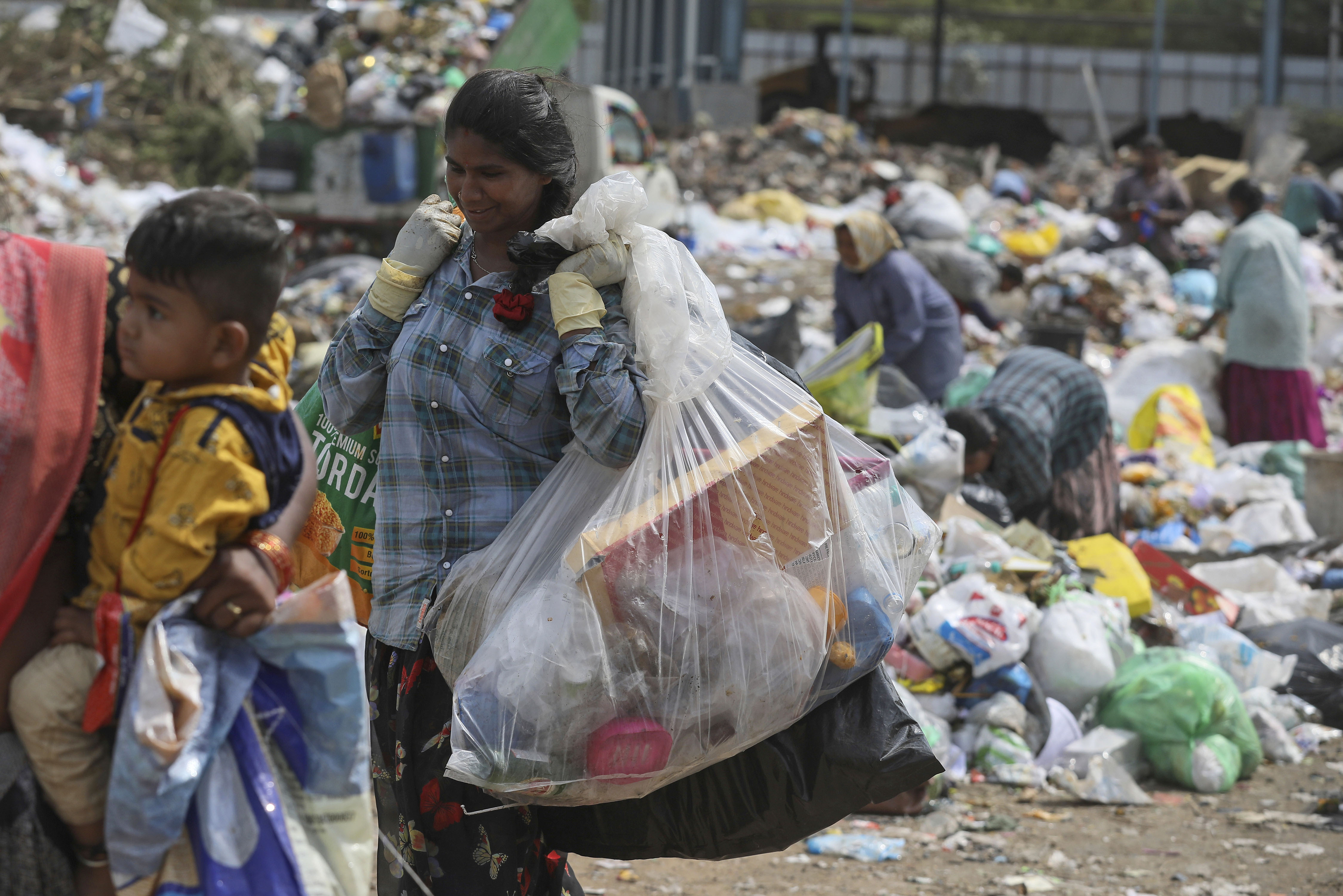 Ragpickers collect reusable material at a garbage dump in Hyderabad, India, on June 4, 2022. (Mahesh Kumar—AP)